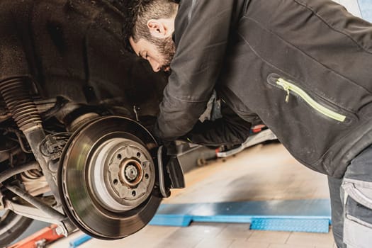 Mechanic Hands Replace Brake Pads on Car