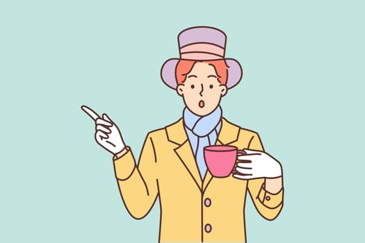 Mysterious man dressed as hatter from story Alice in Wonderland drinks tea and points finger to side