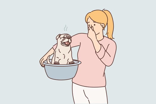 Woman smells unpleasant smell emanating from dog wanting to swim to wash off stench after walk
