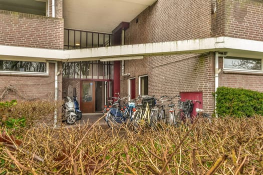 a group of bikes parked outside of a brick building