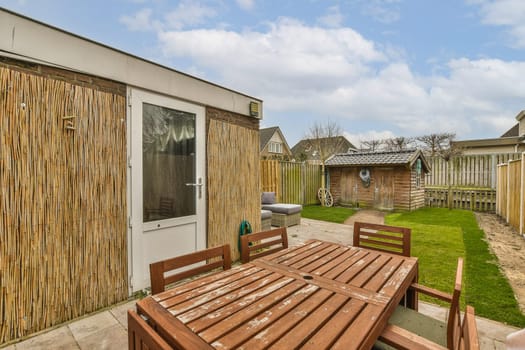a backyard with a wooden fence and a wooden table