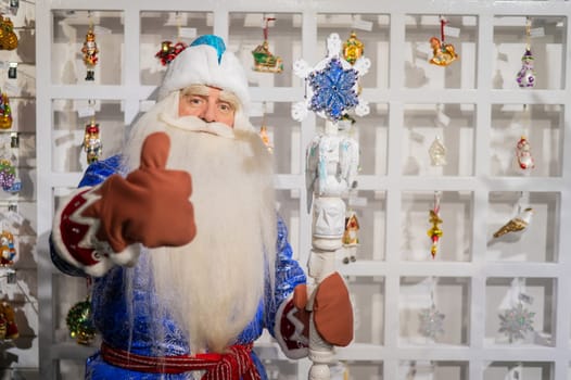 Russian Santa Claus chooses decorations for the Christmas tree in the store.