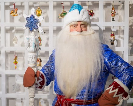 Russian Santa Claus chooses decorations for the Christmas tree in the store.