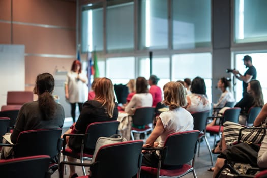 Woman giving presentation on business conference event.