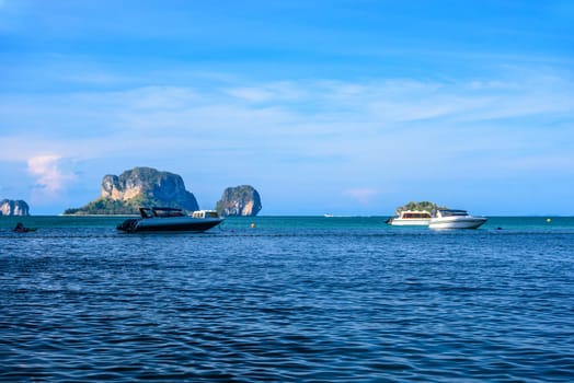Speed boats in the sea with cliff rocks in the background, Ao Phra Nang Beach, Ao Nang, Krabi, Thailand