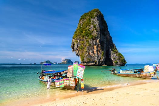 KRABI, THAILAND- MARCH 2018: Long tail boats and cliff rock in azure water, Ko Rang Nok, Ao Phra Nang Beach, Ao Nang, Krabi, Thailand