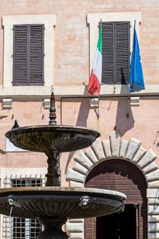spello fountain in front of the common detail of flags