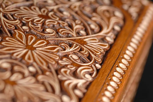 The close-up vintage oriental wooden table with the artistic carving, Uzbekistan