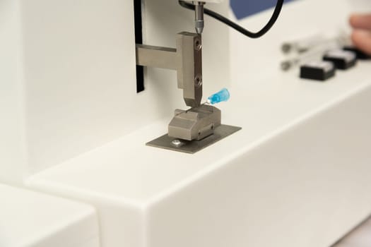 A closeup shot of equipment in a medical laboratory for manufacturing medical syringes
