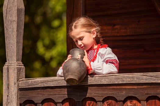 Girl in Ukrainian national dress with a jug