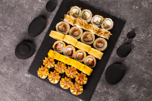 Sushi rolls set on dark background. Japanese and asian food concept