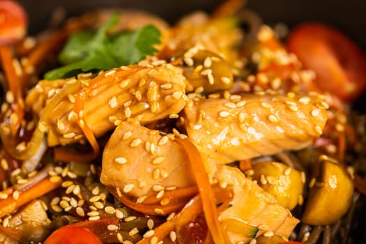 Udon stir-fry noodles with salmon and vegetables. Asian cuisine