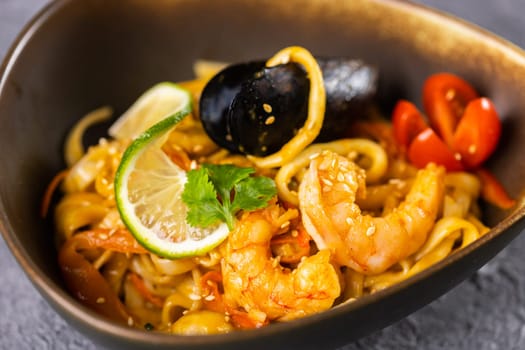 Udon stir-fry noodles with mussels and shrimp. Asian cuisine