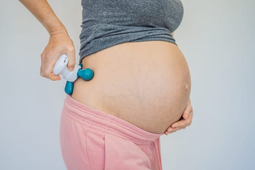 Self-massage with a massager for a pregnant woman
