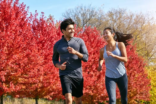 Running to attain and maintain their goals. a sporty young couple exercising together outdoors.