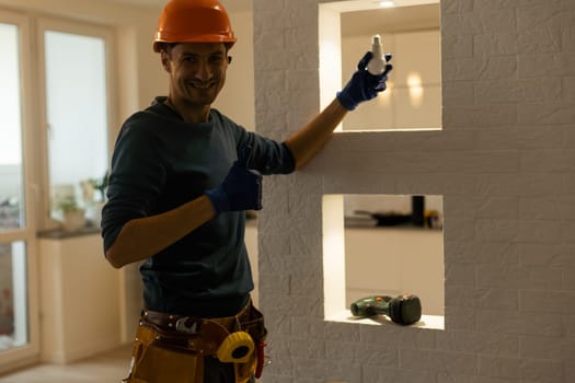 Portrait of an electrician holding an energy-saving lightbulb
