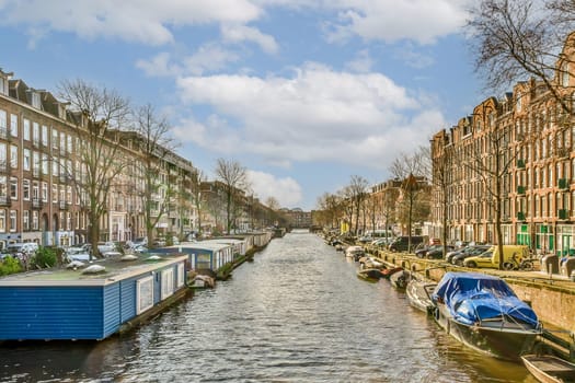 a canal in amsterdam with boats and buildings on