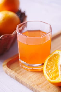orange juice in glass with fresh fruits