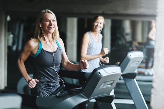 You need to exercise to be healthy. mature women working out in the gym.