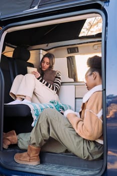 friends relaxing during a road trip in camper van