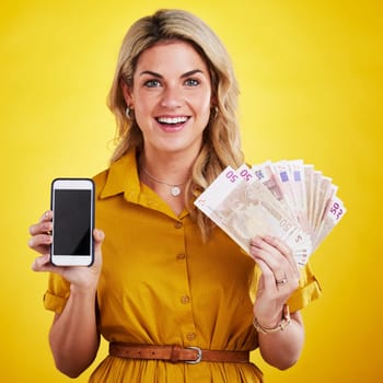 Portrait, smile and woman with phone and money in studio isolated on a yellow background mockup. Cellphone, euros and happiness of female person with cash after winning lottery, prize or competition.