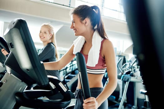 Cardio keeps them trim. attractive young women working out on treadmills at the gym.