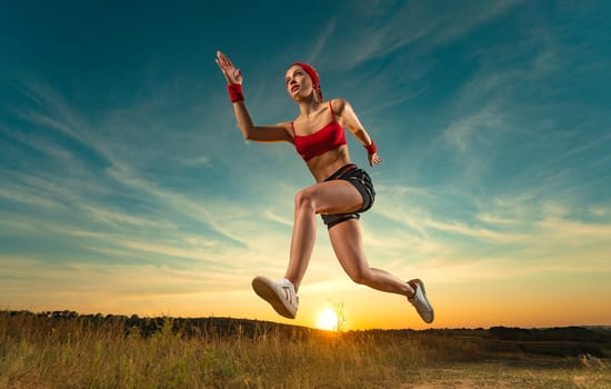 Runner concept. Woman athlete running on the trail. Fitness and sport motivation. Sprinter run. Download photo for advertising a fitness club in social networks. Cover for sport motivation music.