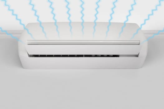 Streams of fresh cool air from a white wall-mounted air conditioner, copy space