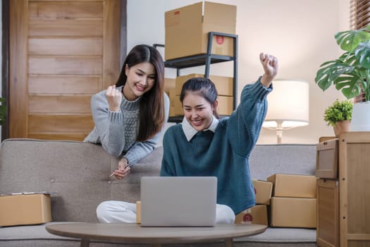 Two Asian Young business woman on sofa at home. startup sme small business entrepreneur SME distribution warehouse with parcel mail box. SME Online marketing and product packaging and delivery service
