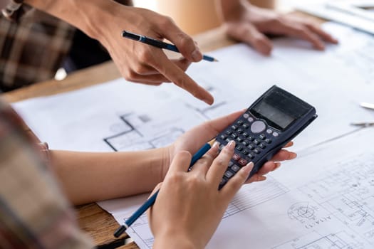 engineer team working in the office, engineer and architect use calculator for calculate drawing design construction