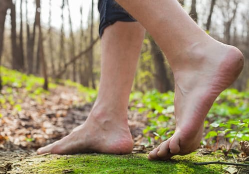 Lifestyle barefoot walk on grass in forest