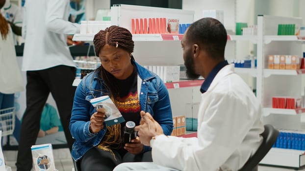 Drugstore employee recommending medicine to client