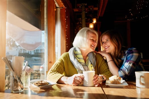 Cosy chats at the cafe are their favourite. a young woman and her senior mother bonding together in a cafe.