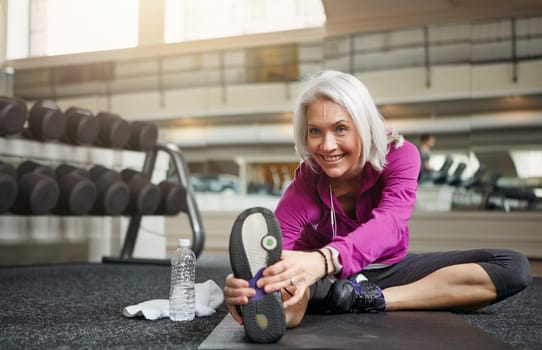 Fitness fanatic in her fifties. a mature woman working out at the gym