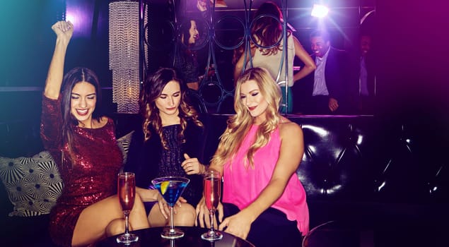 Heres to an epic ladies night. a group of young women enjoying a night out at the club.