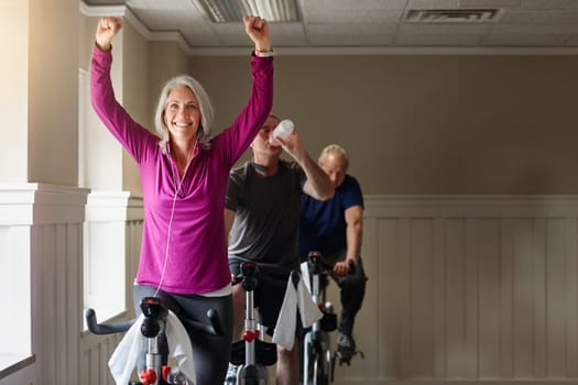 Spinning leads to winning. a group of seniors having a spinning class at the gym.
