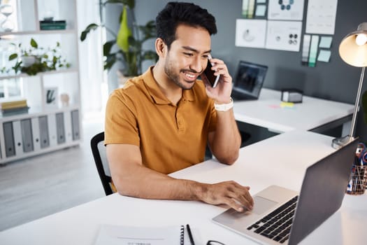 Phone call, smile and strategy with a business man chatting while working at his desk in the office. Mobile, contact and communication with a young male employee chatting or networking for planning.