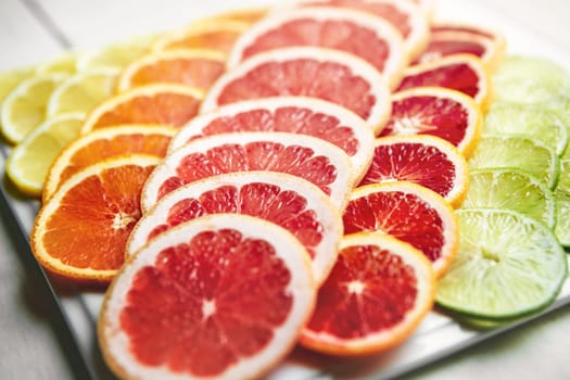 So vibrant, so healthy. a variety of citrus fruits cut into slices on a plate.