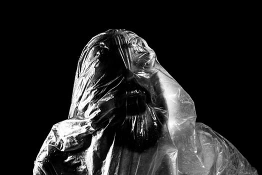 Man with plastic bag over his head, suffocated. Black and white shot. 