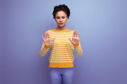 attractive latin young woman with afro hair with stop gesture