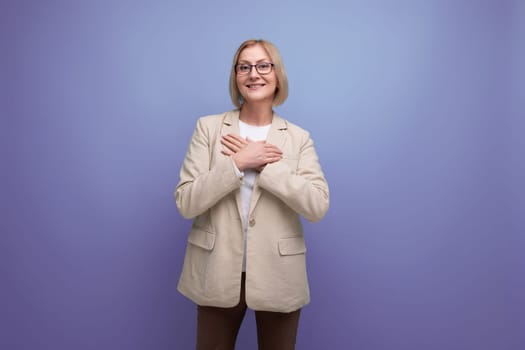 adult 50s woman in a stylish jacket on a bright studio background with copy space
