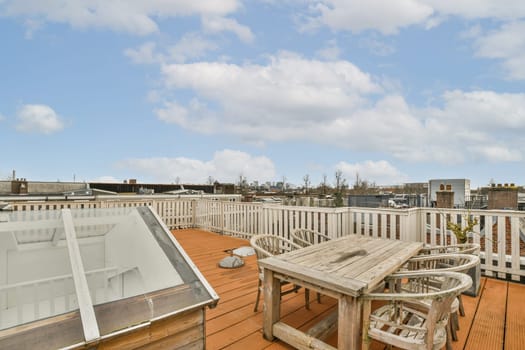 the top of a roof deck with tables and chairs