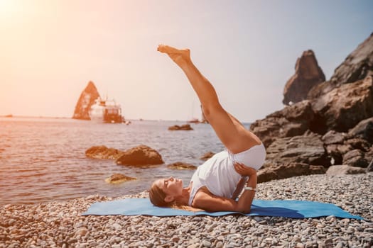 Woman sea yoga. Two happy women practicing yoga on the beach with ocean and rock mountains. Motivation and inspirational fit and exercising. Healthy lifestyle outdoors in nature, fitness concept.