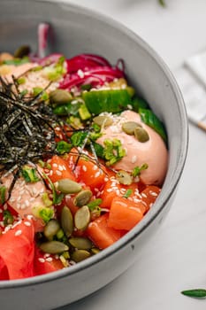 Portion of salmon poke bowl with vegetables