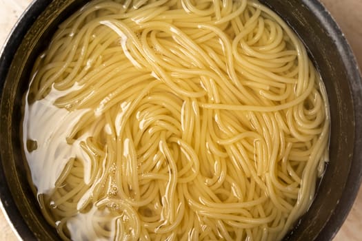 boiled spaghetti in water. Boiling spaghetti in pan on stove i