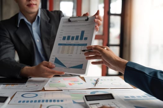 business team discussion of reports displayed in charts and graphs. analyze financial statistics brainstorming business team people review analyze financial reports.