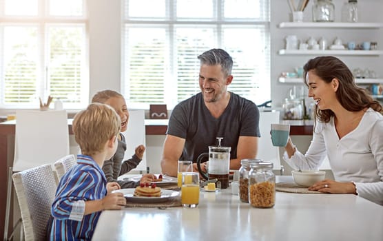 Nobody is funnier than your kids. a family having breakfast together.