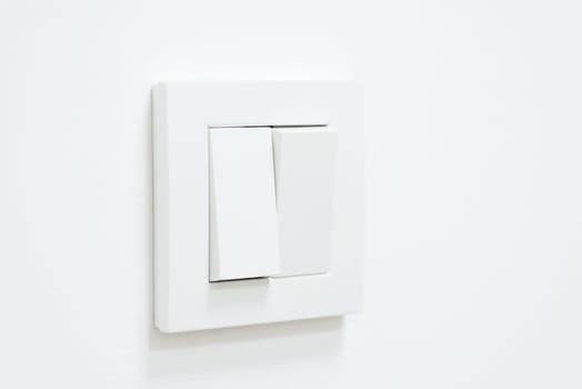 White light switch on white wall