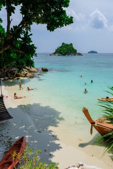 Koh Lipe Island Thailand April 2023, people relaxing in the ocean on a tropical Island with a blue ocean and white soft sand. Ko Lipe Island Thailand