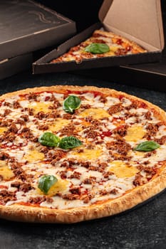 Huge pizza with cheddar cheese and minced beef